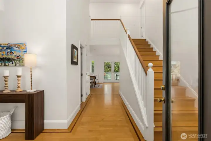 Welcome home to the main entrance with the formal living room to the left, straight ahead to the kitchen/dining area and stairs leading upwards to 3 bedrooms & two baths.  The powder room is on the left of the hall