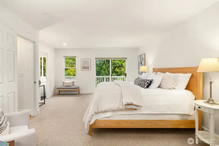 The primary bedroom with sliding doors to a deck.