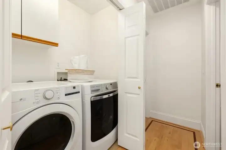 Laundry closet with washer & dryer and storage cabinets above on the 2nd upstairs level.