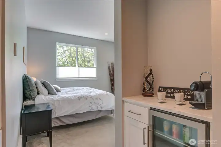 Primary bedroom with its own beverage fridge and coffee station