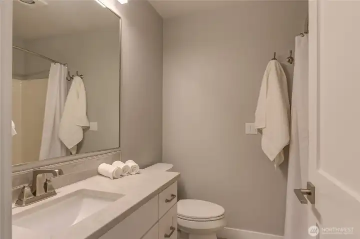 Full guest bath complete with heated tile floors