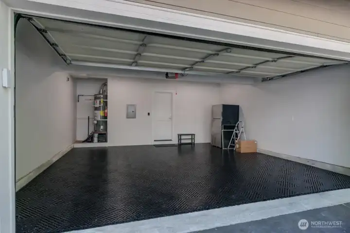 Rendering of showroom garage with finished drywall, LED panel lighting, wireless remote, garage fridge and click tile flooring