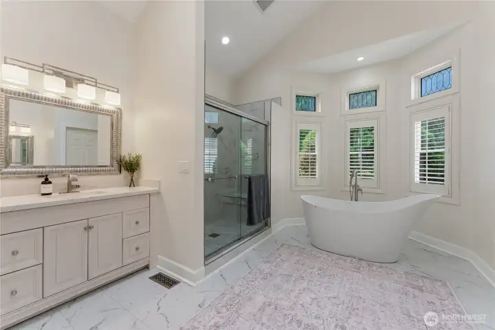 Spa-like ensuite bath with mirror image WICs, vanities, and a divine soaking tub.