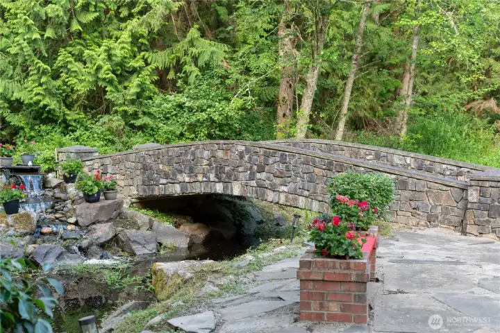 Stone bridge crosses the tranquil pond