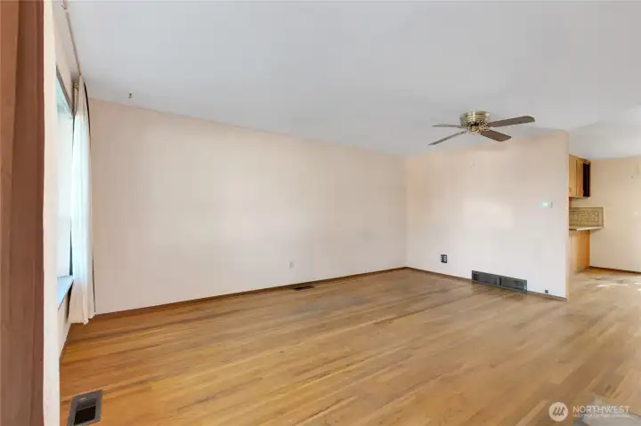 The family/living room is big enough for both! Beautiful original hardwoods, just sand and refinish!
