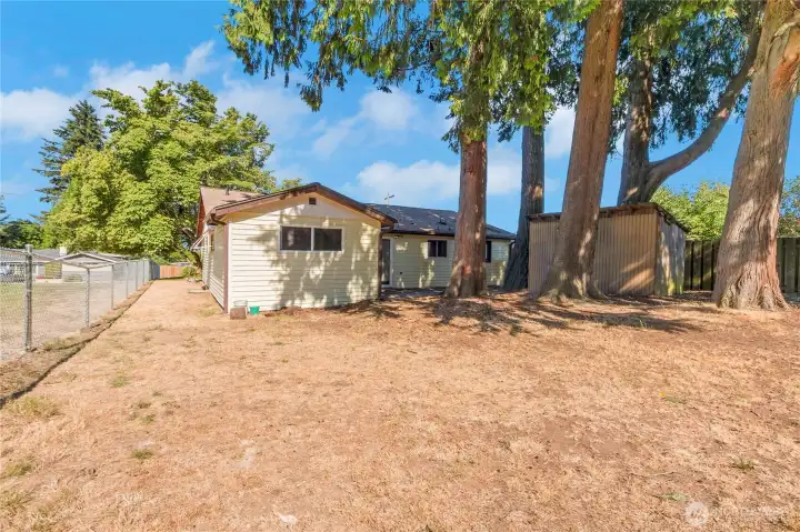 Fuller view of back of home and side yard