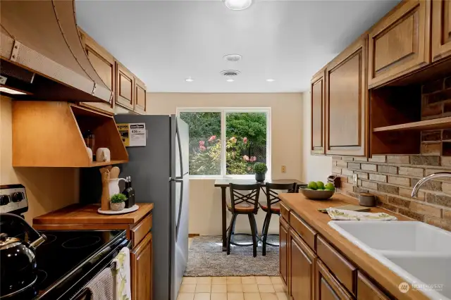 This Pullman kitchen has everything you need to prepare gourmet meals, and it looks pretty good, too, with butcher block counters, ceramic tile flooring, plus a sunny breakfast nook looking out onto the lush park-like back yard.