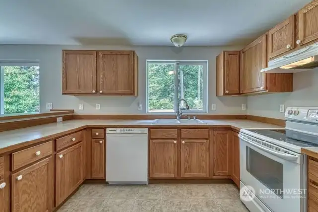 The spotless kitchen has ample counter and cabinet space.