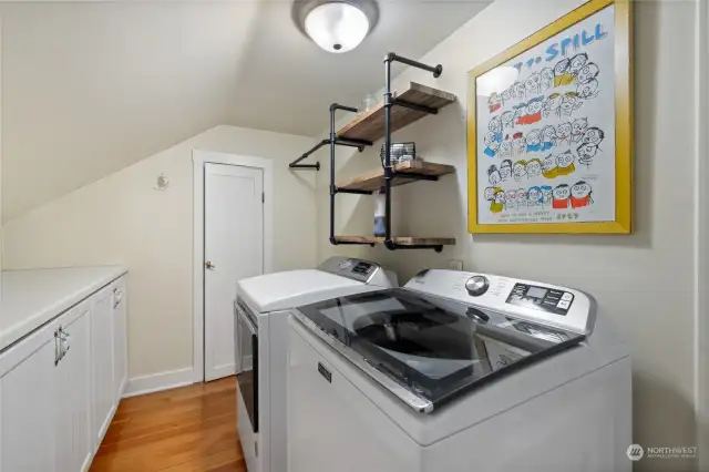 Upstairs utility room offers large counter for folding as well as a secret room with EVEN MORE STORAGE!