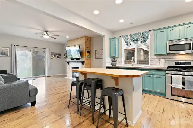 Kitchen with Butcher block island and subway tile backsplash.