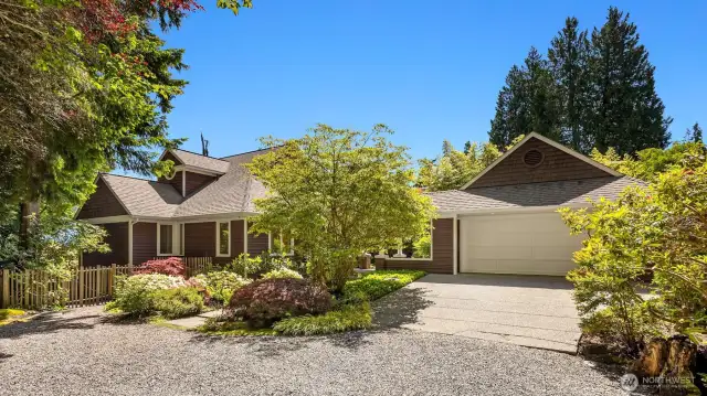 Custom Cape Cod/Craftsman style home with detached garage connected to the home via covered breezeway.