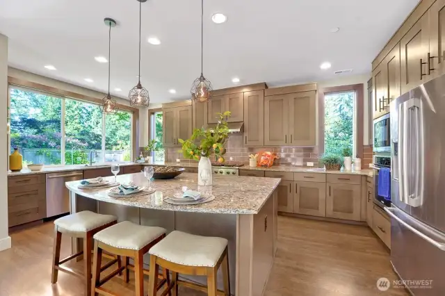 The large slab granite island is a stunning centerpiece providing ample space for meal prep, dining and entertaining.  How about homework hour?  This kitchen is the hub of the house!