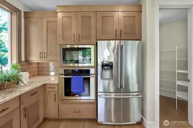 Newer stainless-steel appliances bring a sleek, modern touch to the kitchen while resisting smudges and fingerprints to maintain their pristine look with minimal upkeep.  The door to the right of the picture is the entrance to the large, walk-in pantry