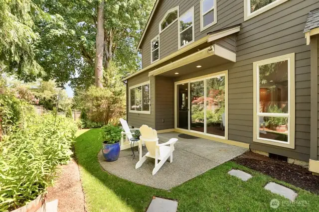 A view of the beautiful patio nestled within a quiet and private garden creating a serene retreat, while blending nature with the entry to the breakfast nook and kitchen area