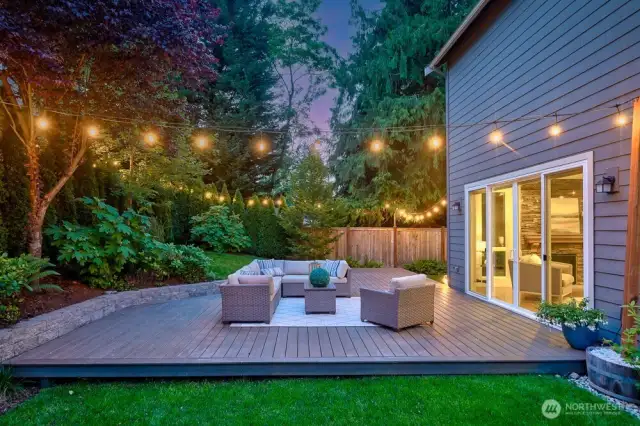 This twilight shot shows the comfortable seating, adorned with soft cushions, inviting relaxation, while the string lights add a touch of warmth and ambiance.  Did I mention privacy?