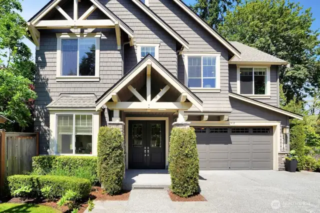 This view showcases the elegance and charm of the home, featuring grand double entry doors that create a welcoming and sophisticated entrance.  The spacious 3-car garage (one tandem) and ample parking in front and to the side ensure that you will have no trouble accommodating multiple vehicles or providing extra space for guests