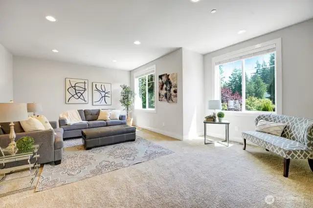 A bright and inviting bonus room offers endless possibilities whether used as a rec/TV room, a home office, or a playroom, the abundant sunlight enhances the room’s warmth and openness