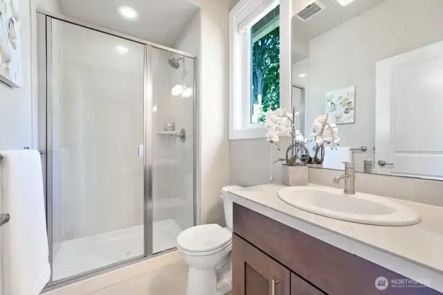 This light and bright ensuite bathroom for Bedroom #3 is both practical and beautiful, offering a perfect balance of functionality and elegance