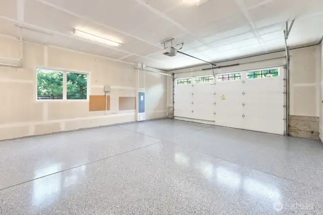 The garage has been refreshed with new epoxy coated flooring, enhancing both durability and aesthetics. The updated surface provides a sleek, low-maintenance finish that resists wear and tear