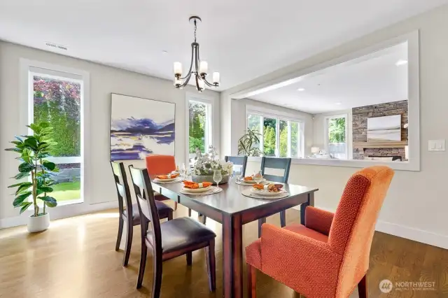 The formal dining area, seamlessly connected to the family room and the kitchen, offers an inviting space filled with natural light and ample room for gatherings. The lovely hardwood floors add warmth and elegance, enhancing the overall ambiance