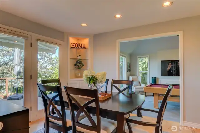 Formal dining and formal room(game room) with french doors to deck