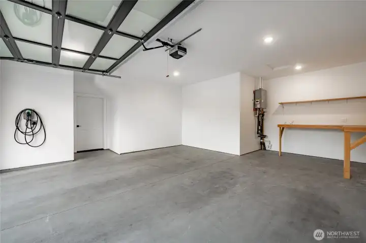 Fully insulated garage (insulation in interior/exterior walls and ceiling). There are two 50 AMP EV plugs and charger, plus a garage work bench with extra electrical plugs for your tools and projects.