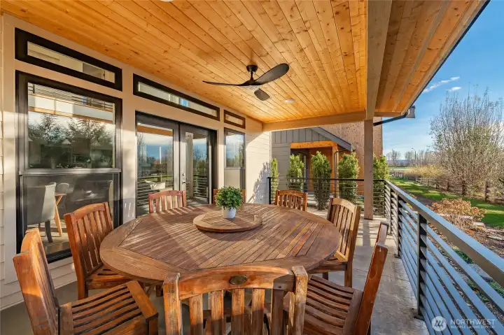 Notice the wood ceiling with clear coat finish that brings out the grain, and black framed transom windows above the picture windows and French door. These are significant details that differentiate this home from all the others.