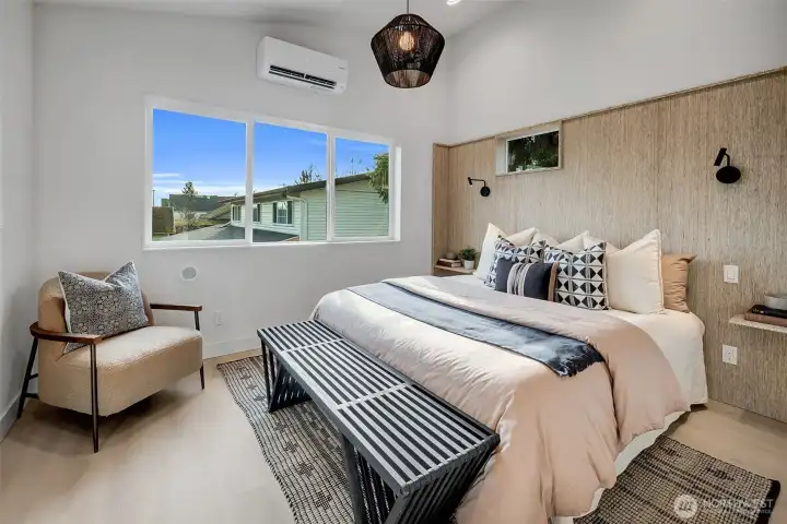 Custom sustainably built accent wall using reclaimed materials features built in night stands and sconces for the perfect retreat.