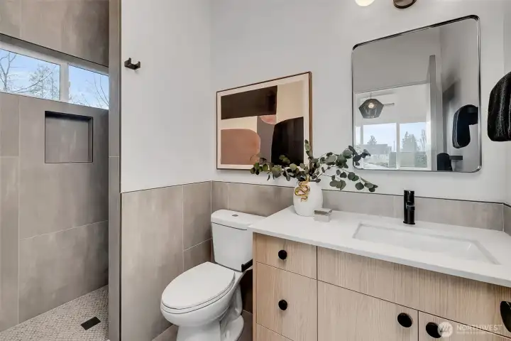 Primary ensuite features walk-in shower and vanity.