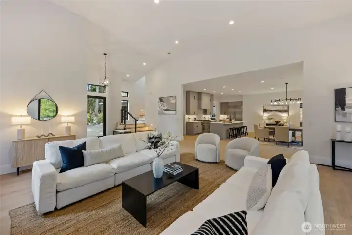 Living area looking into the chef's kitchen and dining space