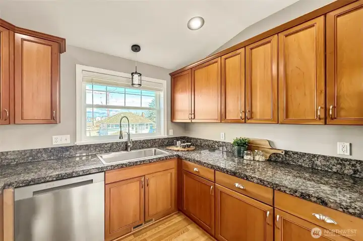 Bright kitchen with granite counters and ample cabinetry