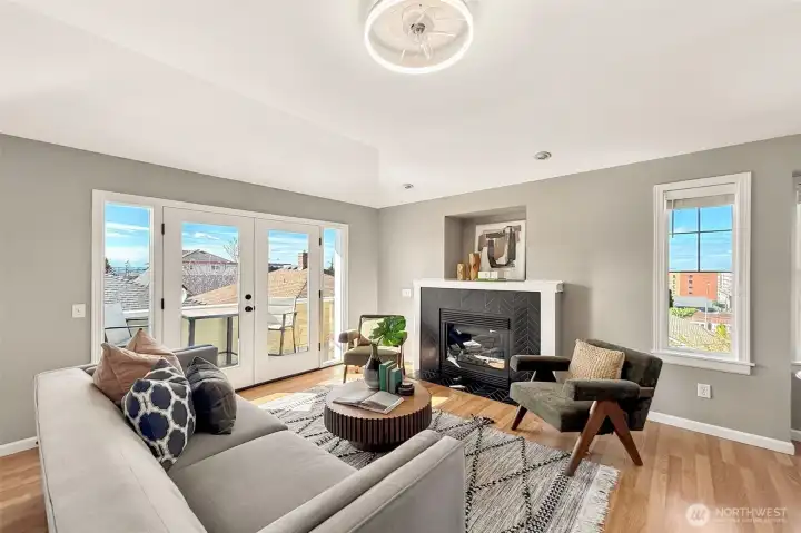 Bright living room with expansive windows and cozy fireplace