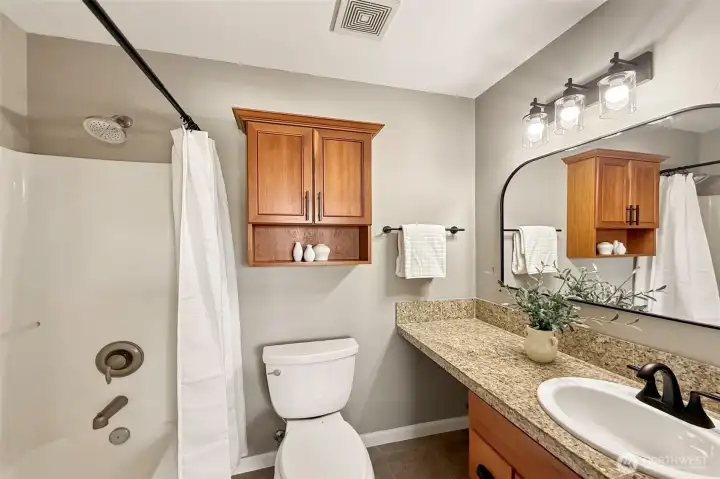 Full en-suite bathroom with vanity and shower/tub combo