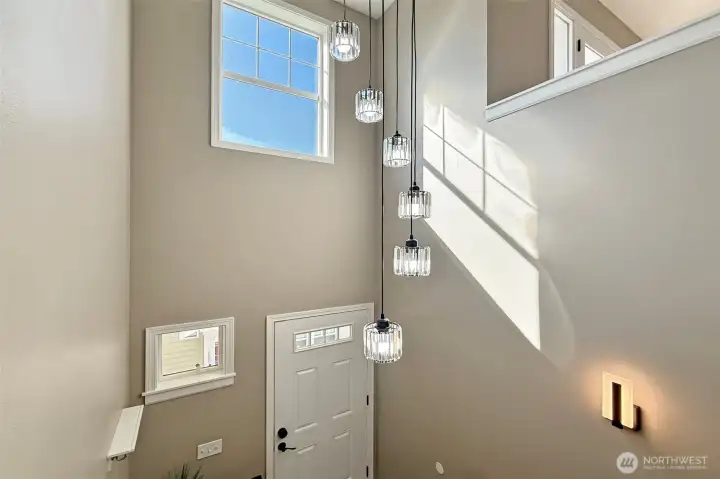 Entryway with high ceilings and modern lighting