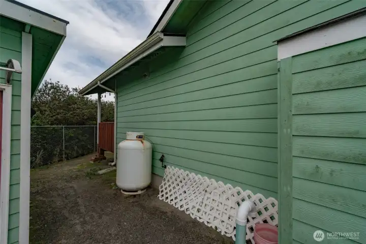 Side of the home showing the propane tank