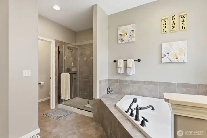 Main floor primary bathroom with tile floors and extra storage