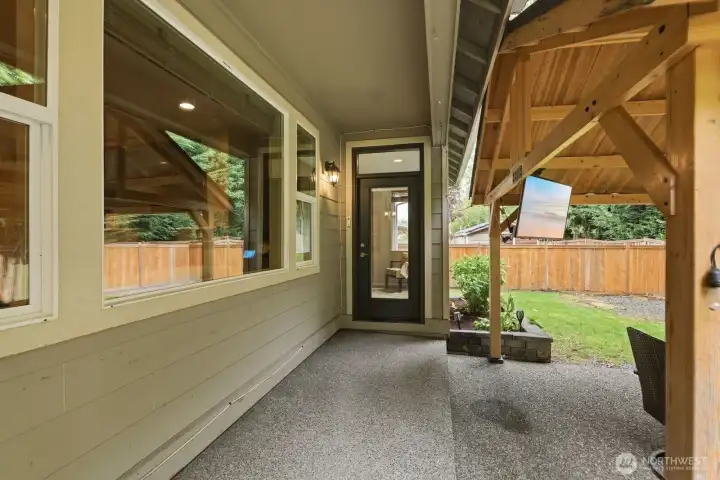 Covered patio space with access from the kitchen and the primary bedroom