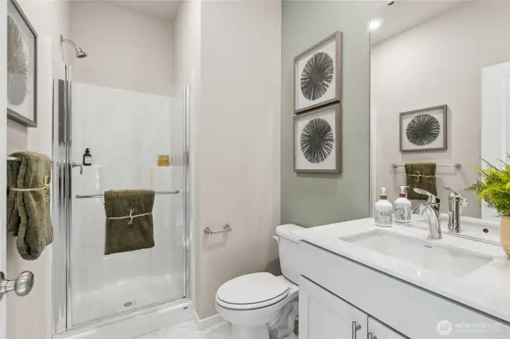 Main floor 3/4 bathroom with step in shower for guests. Photo is representational. Actual home is under construction and colors, materials, and finishes may vary. See site agent for details. Main floor 3/4 bathroom with step in shower for guests. Photo is representational. Actual home is under construction and colors, materials, and finishes may vary. See site agent for details.