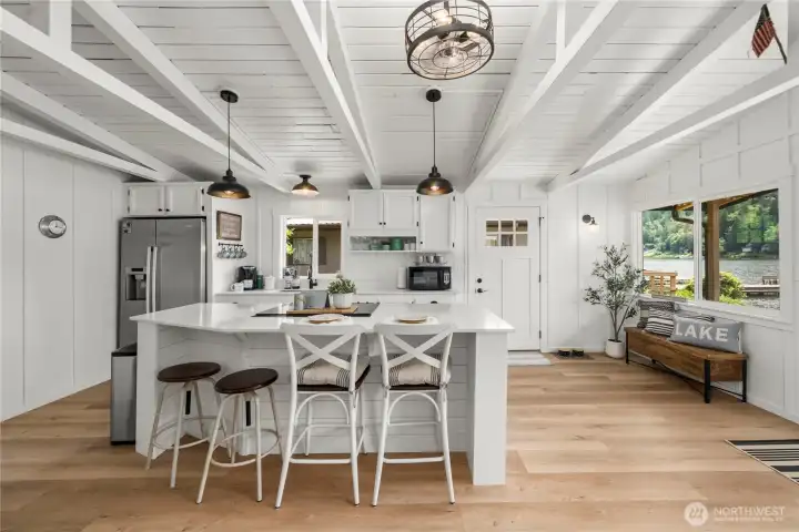 View of the kitchen from the living room.  Open with vaulted ceilings.  This space has been well thought out.