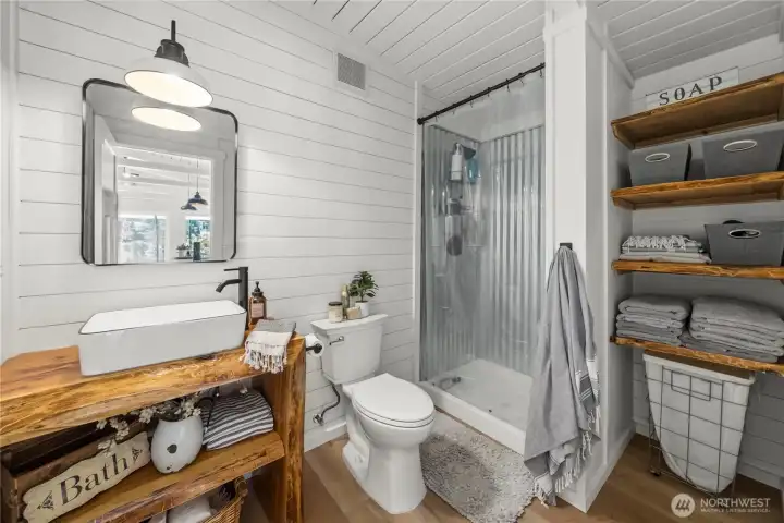 Adorable bathroom with custom vanity and shower.  The coziest and cutest bathroom you ever did see.
