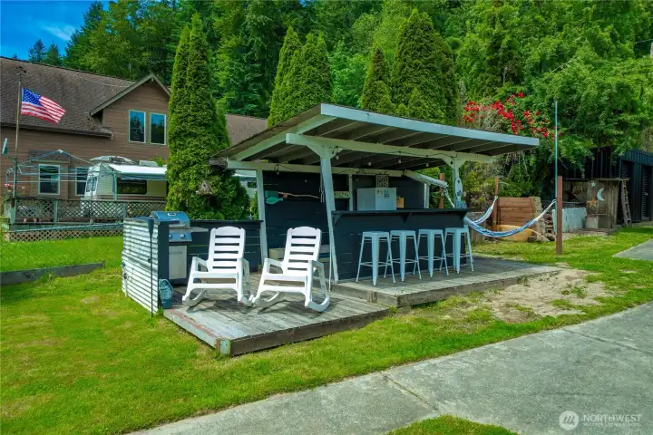 Cabana with eating bar, fridge and area to grill adds to the space especially when entertaining on a hot summer day.