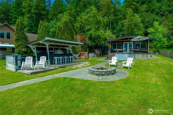 Make memories and have fun in this large yard with firepit, outdoor cabana and grilling area.  Lots of room for outdoor yard games.