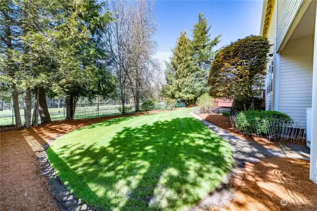The yard is level and partially fenced, with plenty of room for gardening and enjoyment