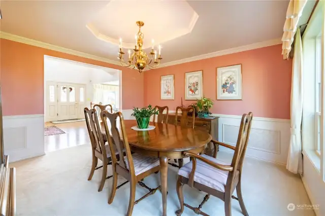 The formal dining room, with wainscoting, chair rail molding and a coved ceiling.