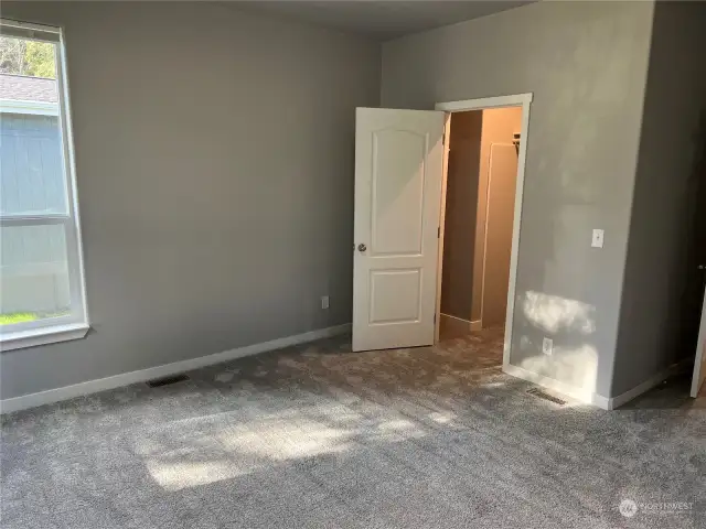 Primary bedroom looking at walk in closet.