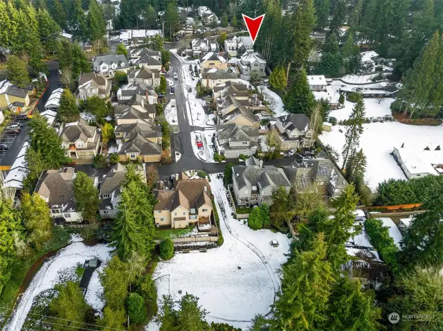 Logan Place Drone Photo shows the large community Park in the foreground and the red arrow to the home for sale