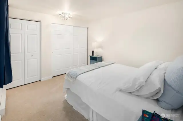 Primary bedroom offers an abundance of closets and storage opportunities.