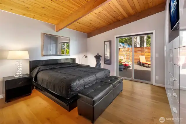 Primary bedroom on main level with private patio access.
