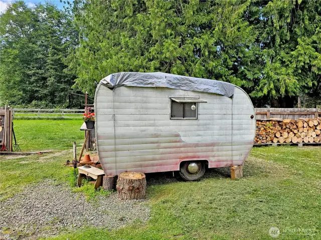 A small travel trailer comes with the purchase!
