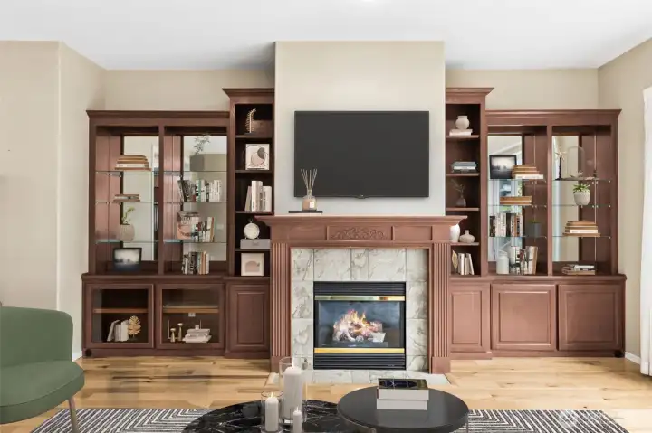 Living room focal point with gas fireplace and mantle. Custom built in's